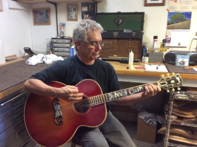 Marty Lanham of Guitar Craft Academy Nashville plays a Gibson J-200 guitar originally owned by Johnny Cash, which he rehabilitated for Marty Stuart, the guitar's current owner.